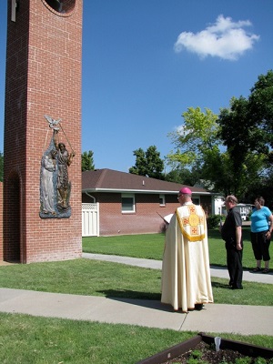 Bishop James Conley and Fr. Mark Pfeiffer as the Bishop blesses the new sculpture of the Baptism of Christ on the bell tower, June 29, 2014