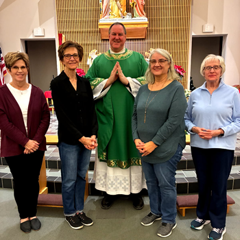 Father Harlan Waskowiak; Jenny Hoarty, treasurer, Bev Reiman, president, Carol Reinsch, secretary, and Janet Goering, vice president.