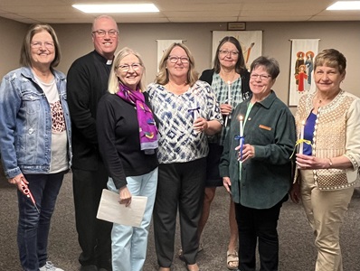 Outgoing officers, Margie Hoffman & Carmen McKenney; Fr. John Sullivan, Current officers: President: Becky Bartek, Secretary: Linda Neujahr, Vice President: Sandy Elder & Treasurer: Cathy Ochs.